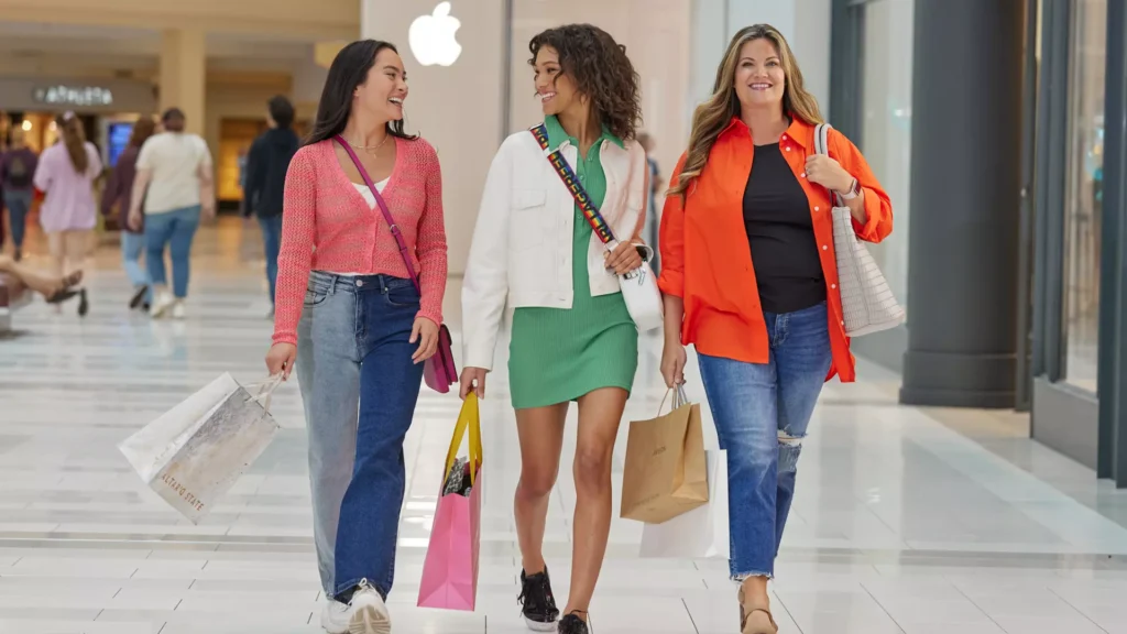 Three women shopping in a mall.